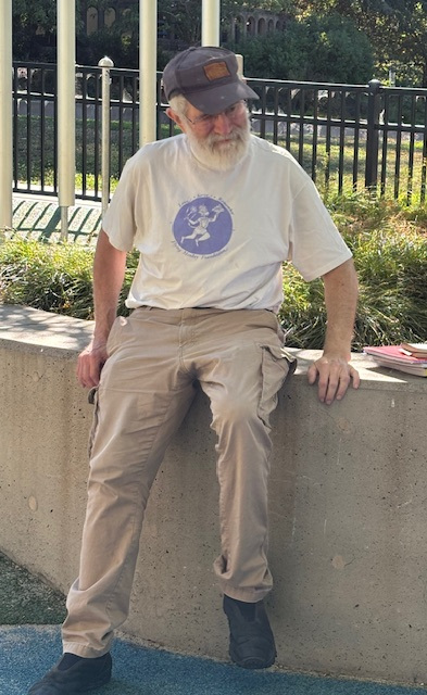Eric sitting on a stone wall